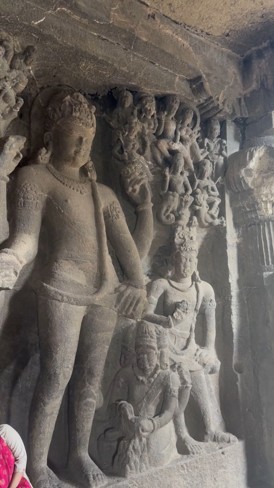 Carved figures on an ancient cave wall.