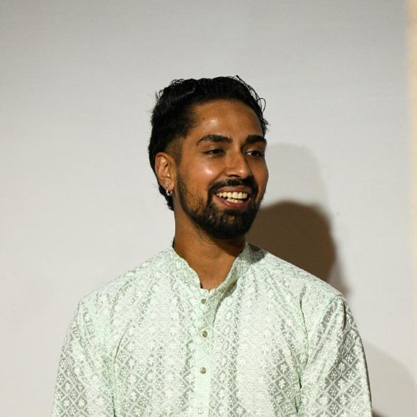 Portrait of Sandesh Adhikari smiling, in a light green kurta.